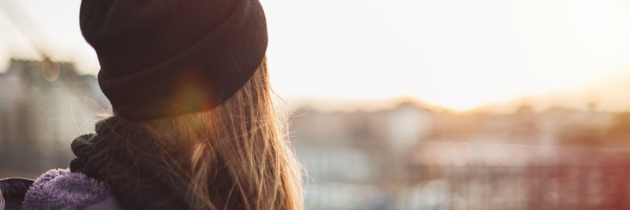 What It's Like Losing Weight From Gastroparesis girl walking on the city street looking at sunset