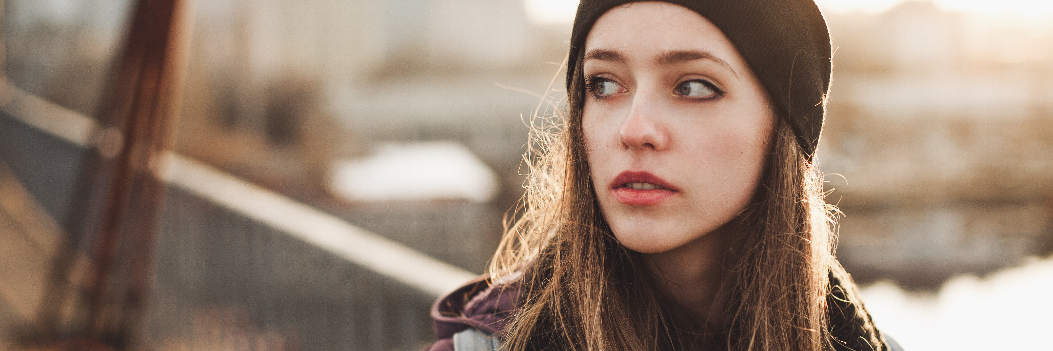 Student With Borderline Personality Disorder Experience young woman wearing hat walking along bridge