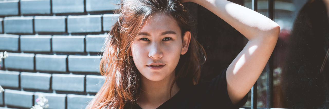 What My Workplace to Know About Having Chronic Suicidal Thoughts A woman running her fingers through her hair