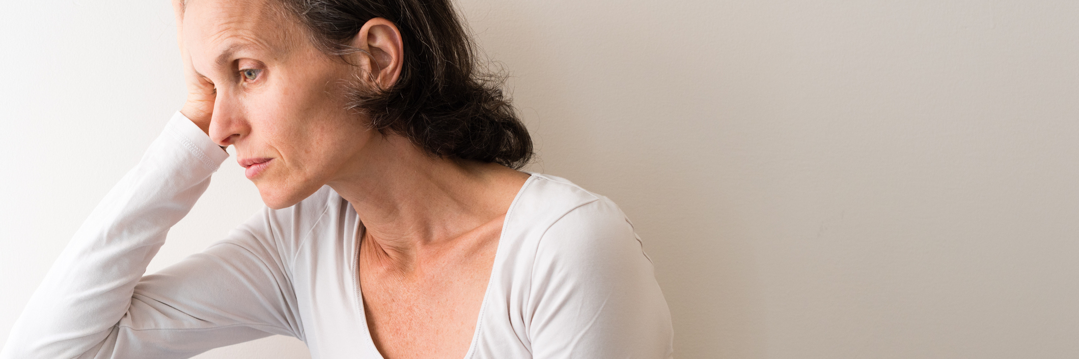 What Each Day Is Like for Someone With Chronic Pain, Illness woman leaning against railing looking tired