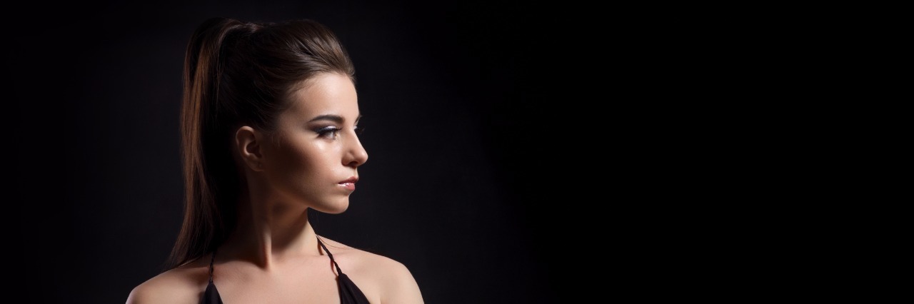 When My Chronic Illness Creates the Feeling of 'FOMO' Woman with arms crossed with a serious expression.