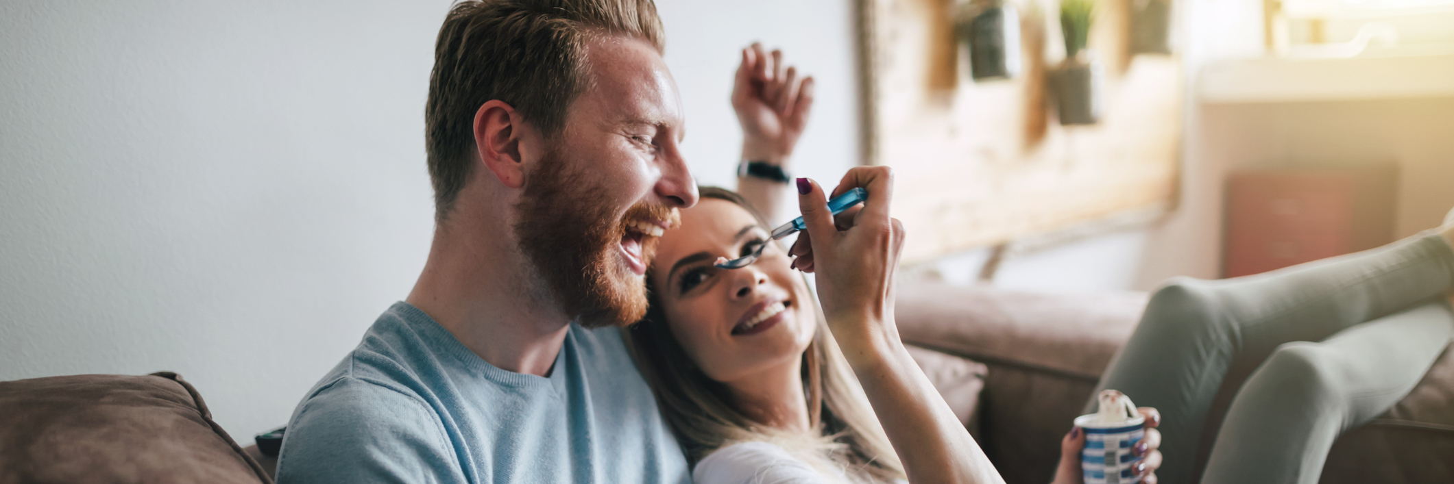 To My Boyfriend: When You Saw Me Have a Seizure for the First Time A couple sits together on a couch, eating ice cream.