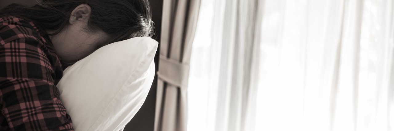 What I Want You to Know When You Ask If You Can Help upset woman alone hugging pillow and crying