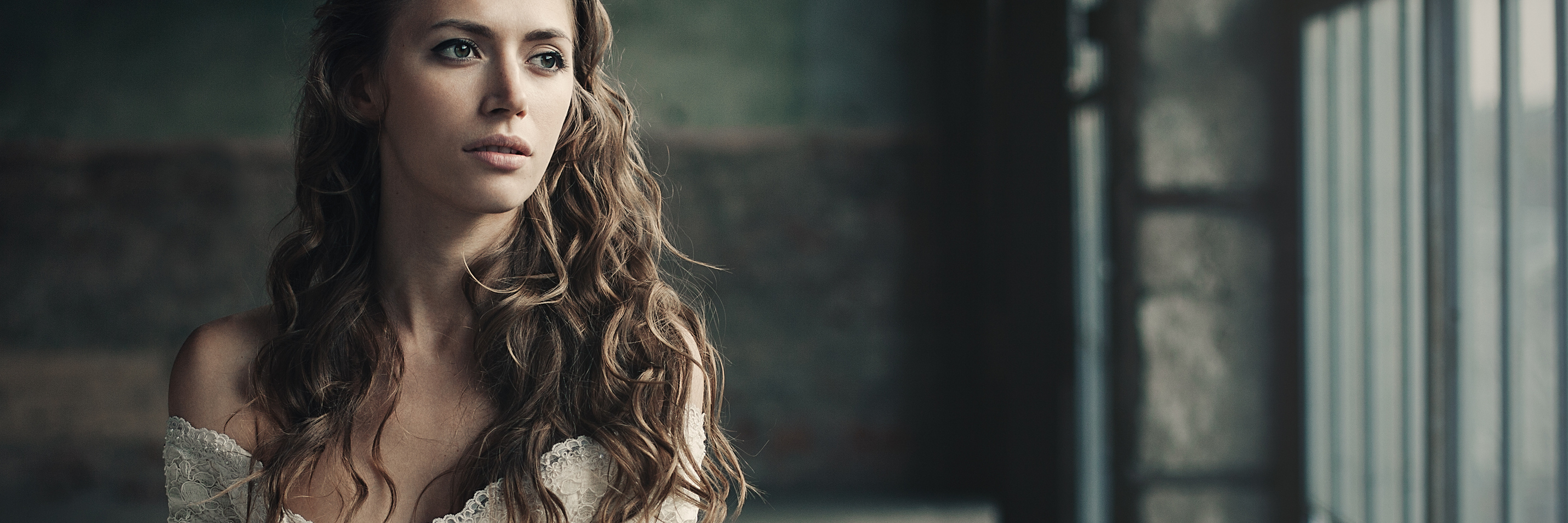 Why My Perfectionism Is My Biggest Flaw woman in white vintage dress standing by loft window looking upset