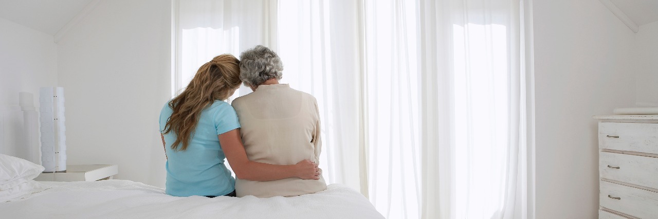 Dear Mom, Who Supported Me Through My Eating Disorder mother and daughter sitting on bed hugging