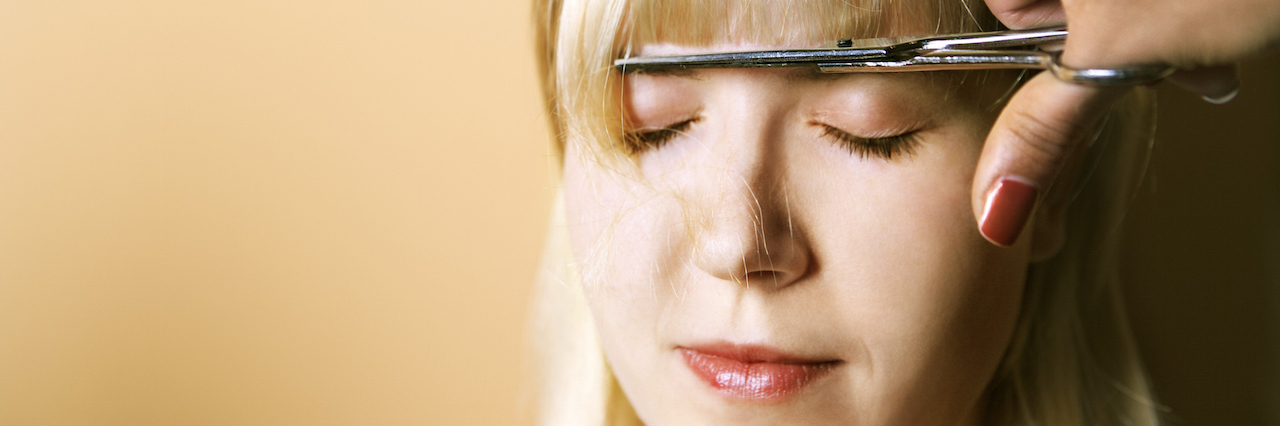 What a Hair Cut Taught Me About Living With a Mental Illness A woman getting her bangs cut