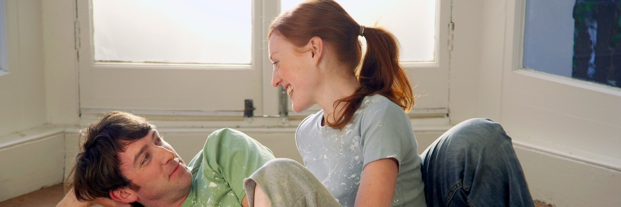 7 Ways I Help My Spouse Feel Secure During My Depressive Episodes Couple relaxing on an empty floor