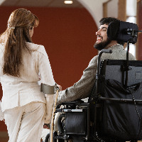 Woman and man with cerebral palsy talking.