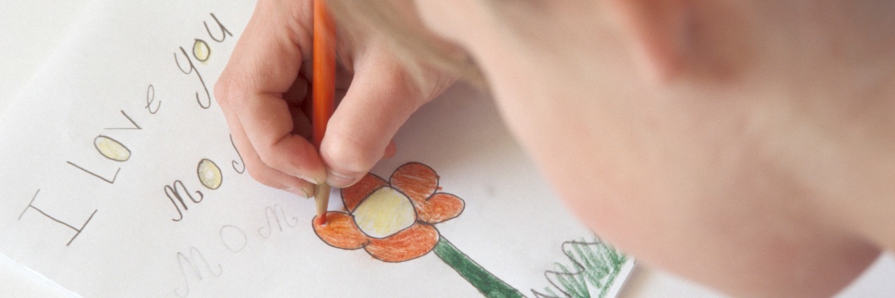 When I Realized All My Daughter's Homemade Cards Mentioned My Pain Girl making card for mom.