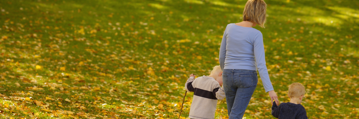 Learning From My Sons on the Autism Spectrum Mother walking on grass, holding hands of her two sons