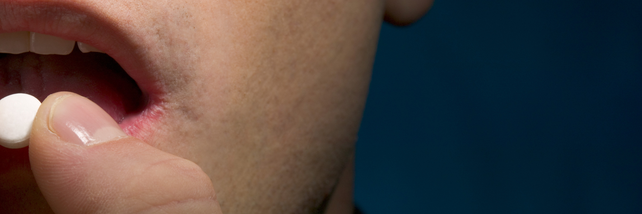 Please Stop Judging Me for Taking Pain Medication Close-up of a man taking pill.