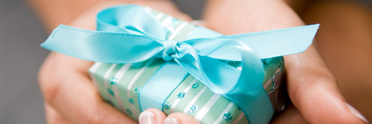 Cerebral Palsy Is a Gift Hands holding gift.