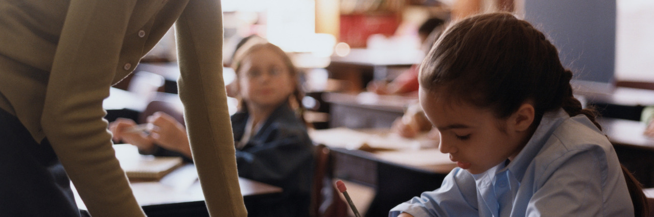 School Experiences With Nonverbal Learning Disability Teacher helping a student.