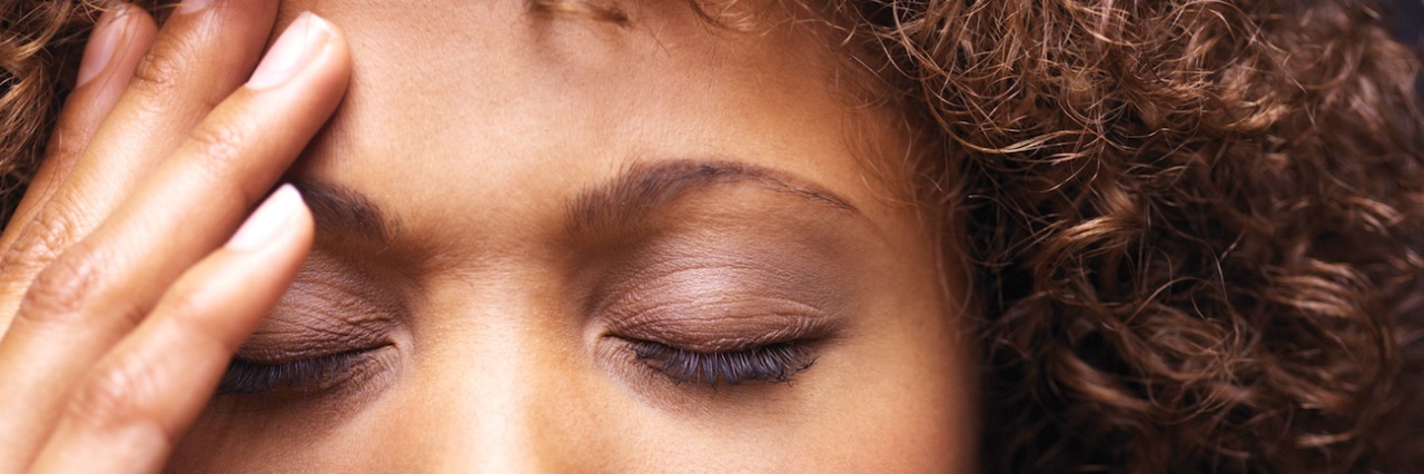 Chronic Pain and Fatigue Make Me Feel Like the ‘World’s Worst Mom’ Woman with eyes closed and hand over part of forehead