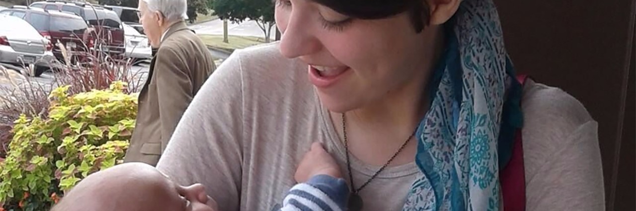 I Wanted to Die This Morning and What Helped Me Through It contributor holding young baby in her arms and wearing bandana