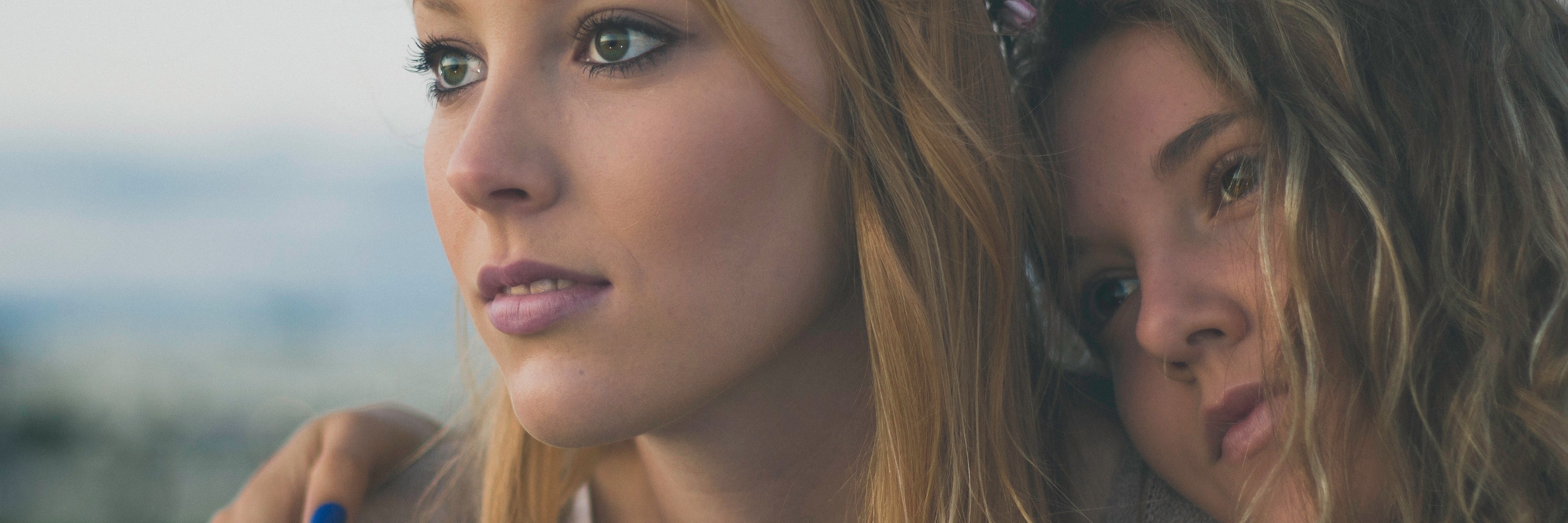 Thanking My Mental Health Support Network for the Little Things two women hugging watching sunset care together