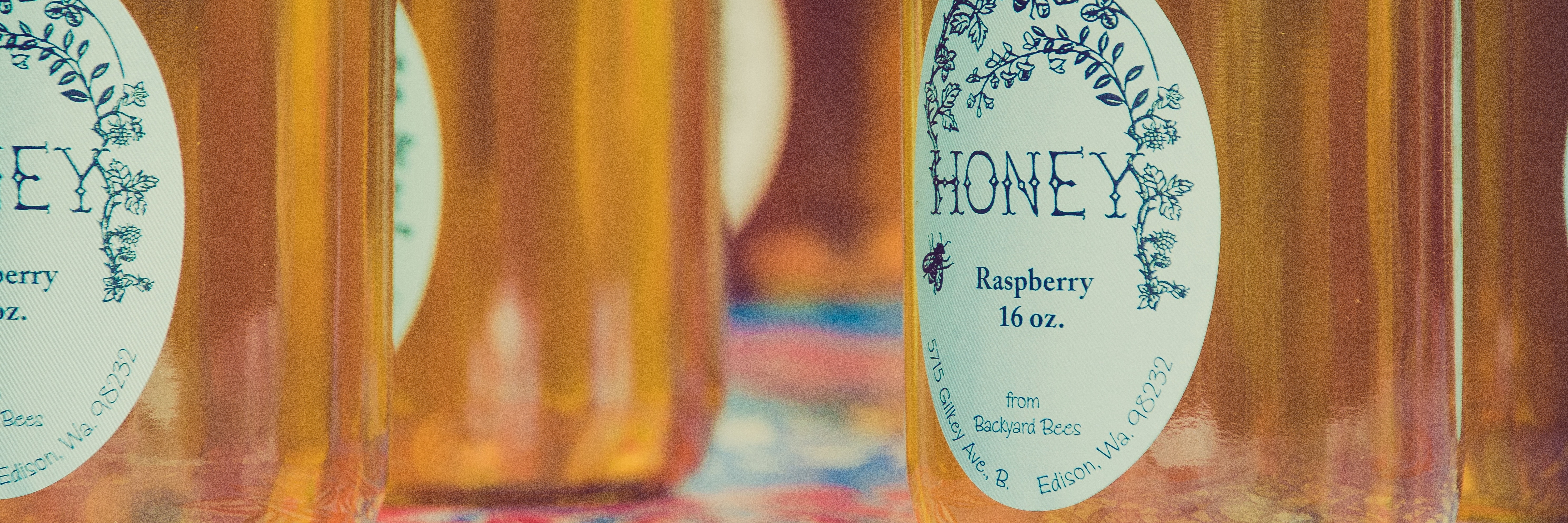 The Truth About Mental Health Labels and Stigma jars of raspberry honey with labels sitting on floral cloth