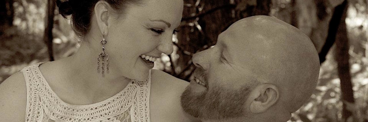 Celebrating Birthdays, Holidays and Anniversaries With Lyme Disease husband and wife hugging and laughing with each other