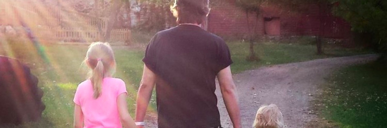 A Mother's Day Poem for Those Who Have Had Miscarriages man holding hands with two kids while walking on path