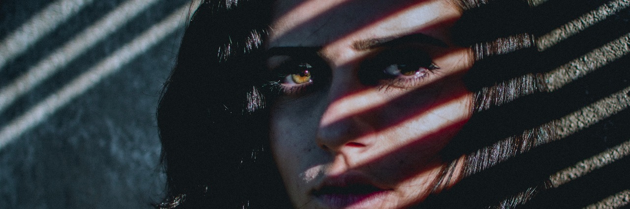 How Can You Someone With a Mental Illness When You Don't Get It? woman with shadows from blinds