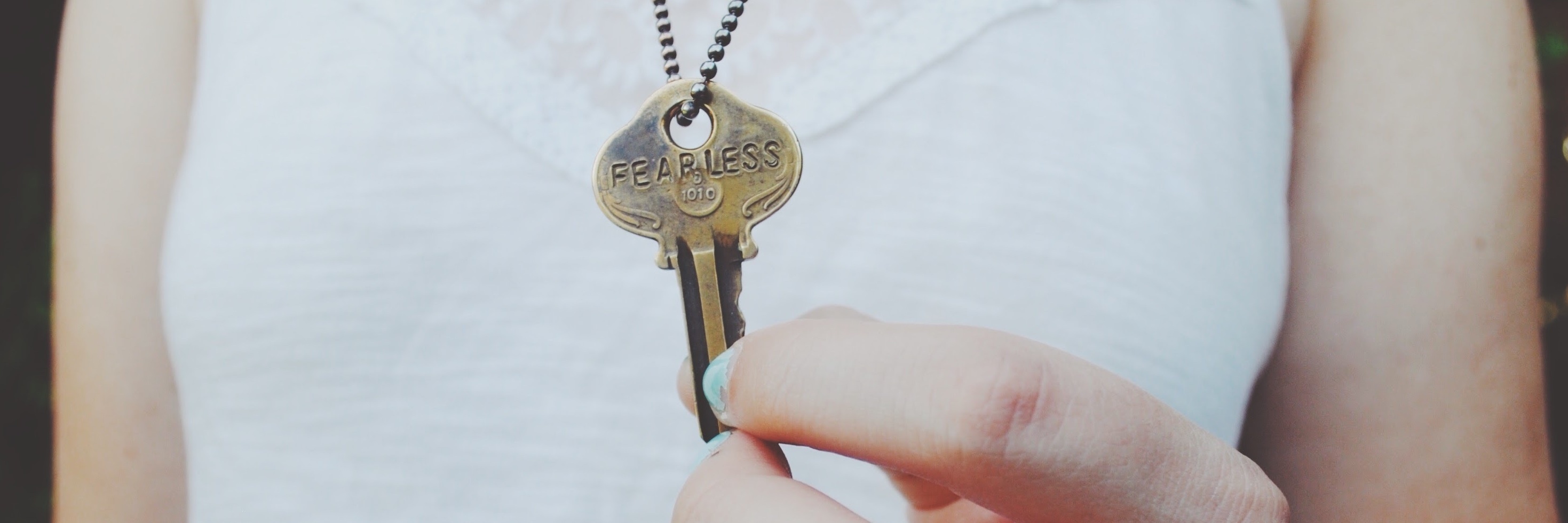 How I Struggled Accepting My Bipolar Disorder Diagnosis photo of woman holding key with word fearless printed onto it