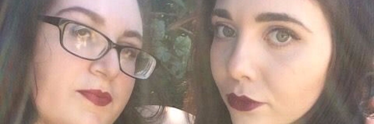 Ehlers-Danlos Syndrome: Being Admired for Your Flexibility two female friends wearing black clothes and purple lipstick and smiling