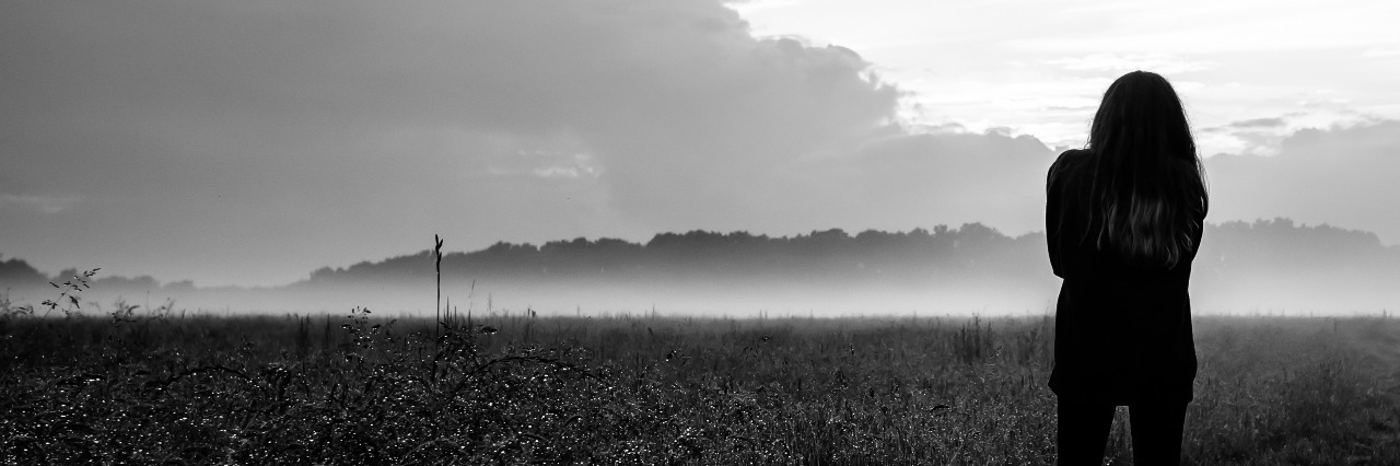 When Mental Illness Makes You Spend the Day on Autopilot black and white woman standing in front of misty field