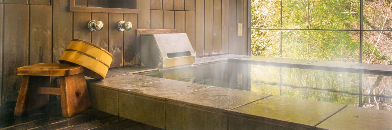 The Naked Truth About Eating Disorder Recovery close up of japanese onsen or hot thermal bath filled with golden light