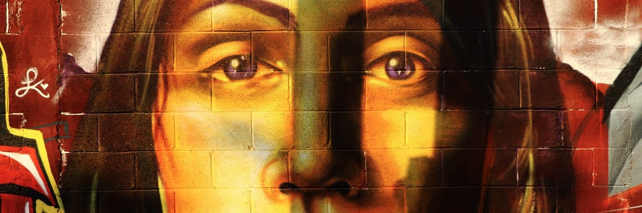 Why My High-Functioning Anxiety Means I Must Be a 'Liar' street art of woman in vibrant colors looking sad or upset