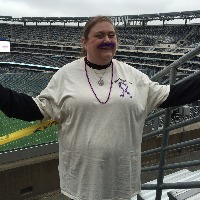 woman wearing a lupus awareness tshirt and standing in a football stadium