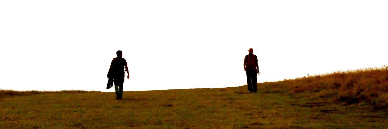 Why Mental Illness Looks Different for Everyone two people walk down a hill together