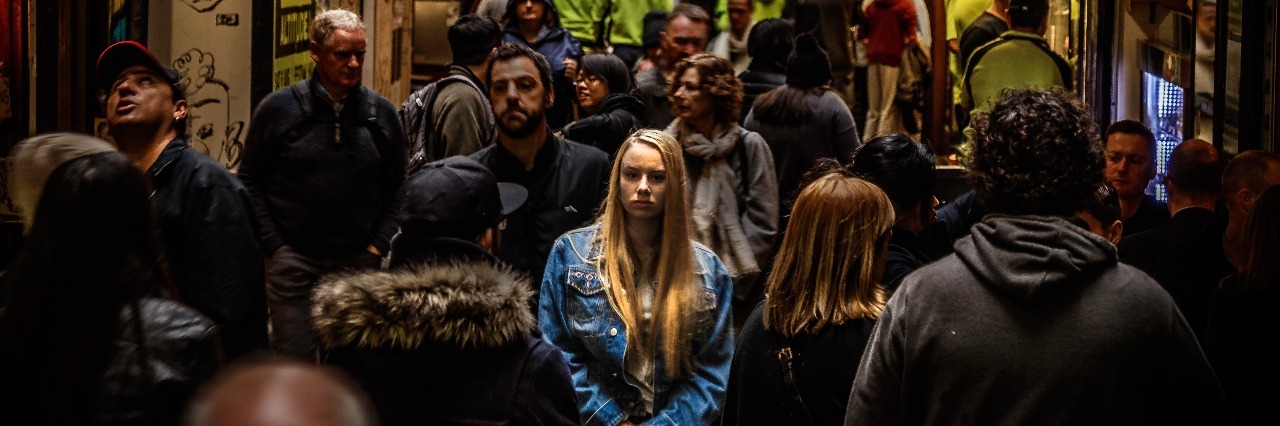 Why It's Important to Admit When You're Struggling young woman looking sad while standing alone in busy street