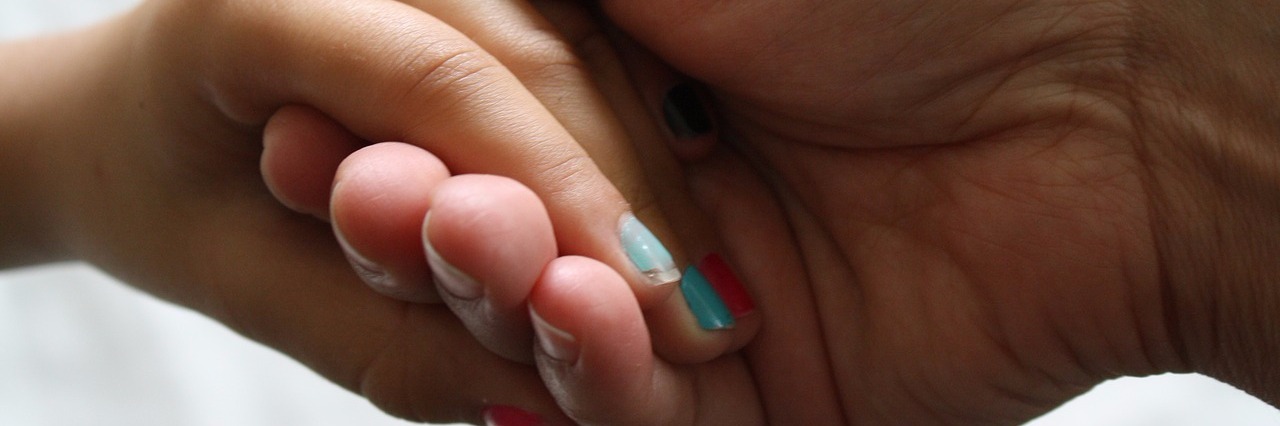 Allowing Child to Learn Resilience After Ehlers-Danlos Diagnosis mother holding her daughter's hand