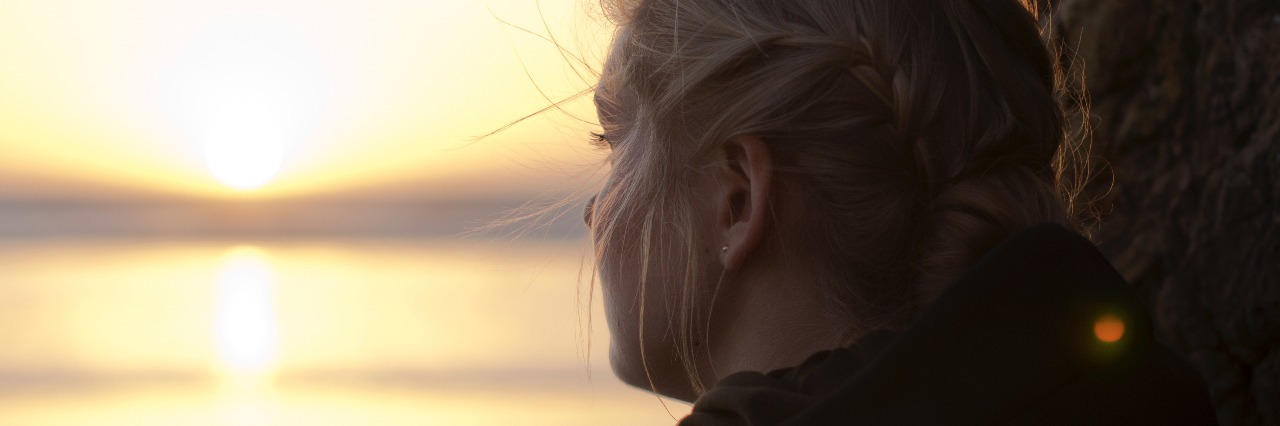 Why I'm Going to Keep Attending My Counseling Sessions teen looking out over lake at sunset