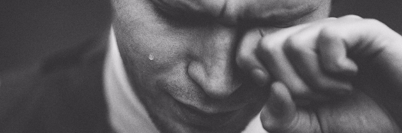 How a Simple E-Mail Sent Me Into a Depressive Episode black and white image of man wearing suit crying with tear on cheek