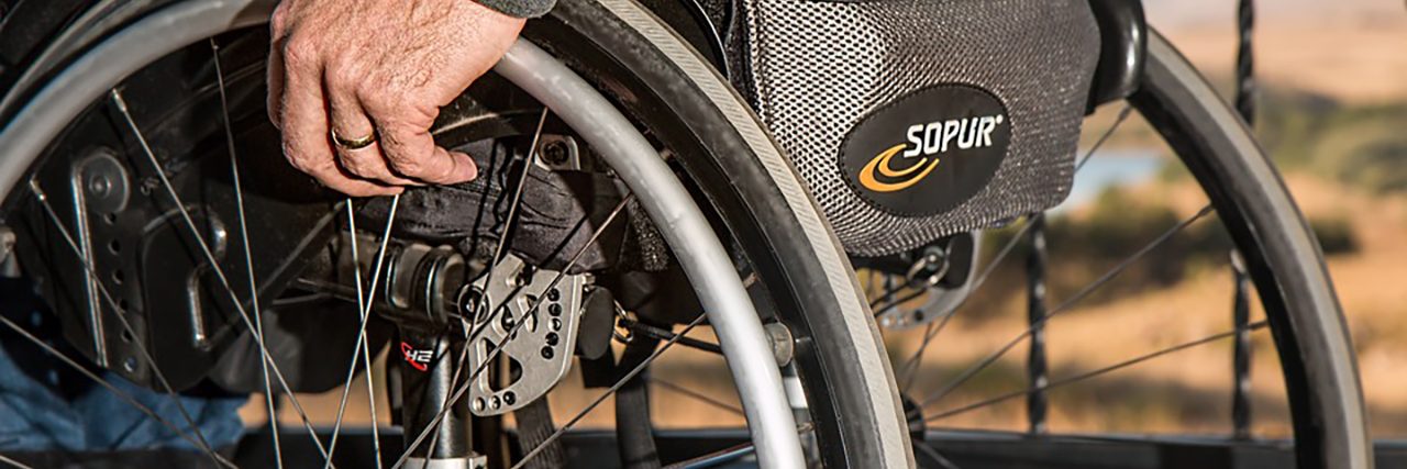 Tips to Make Your Workplace Disability-Friendly Man pushing his manual wheelchair.