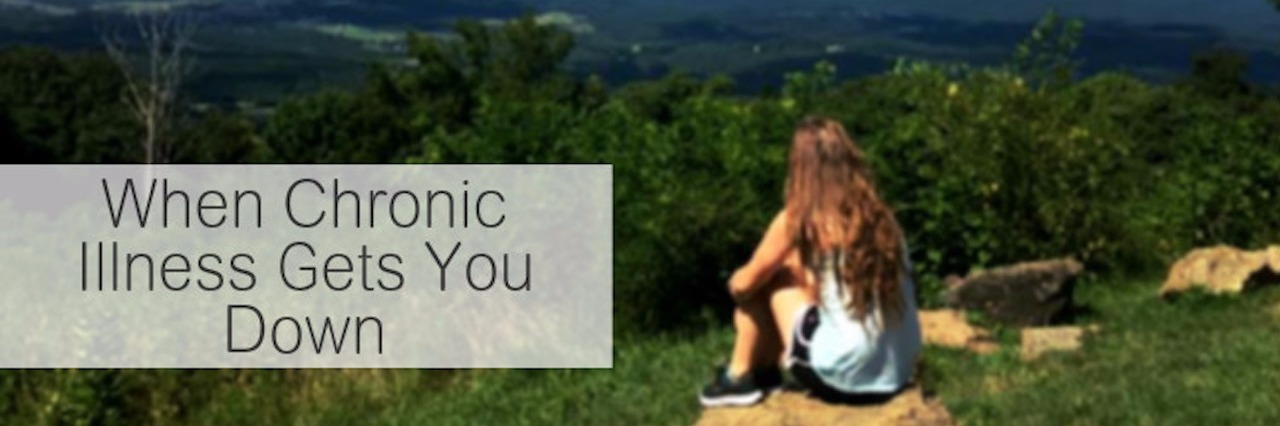 Joint Hypermobility Syndrome: Mental, Emotional Effects of Illness young woman sitting on a rock overlooking a valley with text saying 'when chronic illness gets you down'