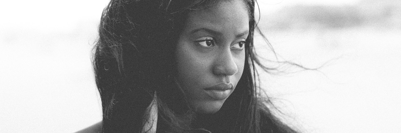 black african american teen monochrome looking sad away from camera with hand in hair