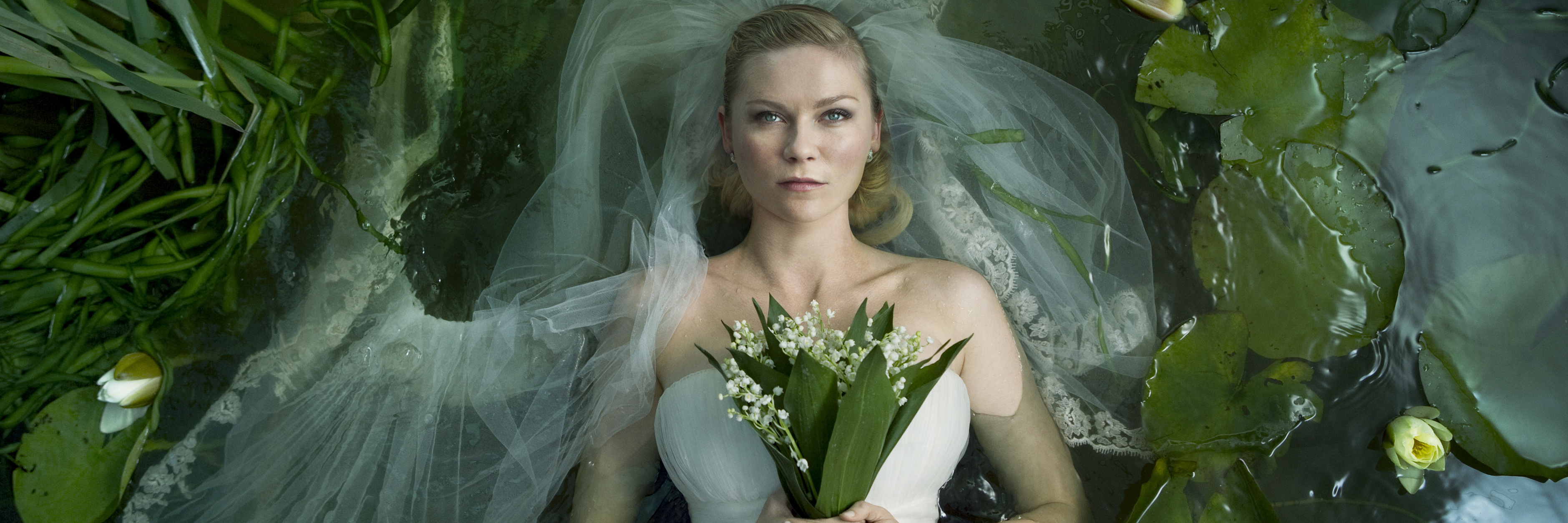 Movies About Mental Illness and How I Relate to Them melancholia image of kirsten dunst holding flowers