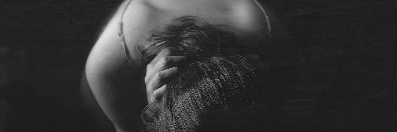 Photography to Represent Aspects of Depression Black and white image of photographer's representation of how depression affects her body, woman arched over with hands behind neck showing back