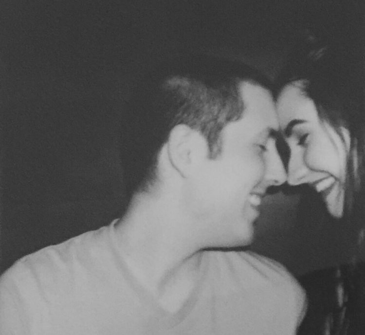 black and white photo of woman and her boyfriend smiling at each other