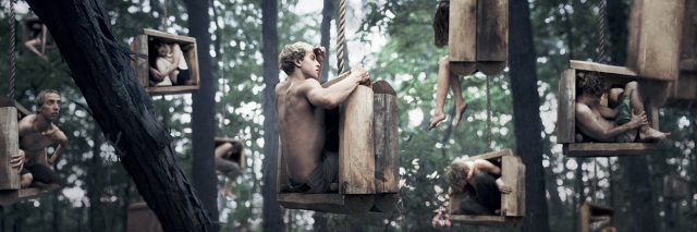 an abstract image of men sitting in boxes hanging from trees