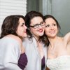 image of three women taking selfie and smiling, one wearing a wedding dress