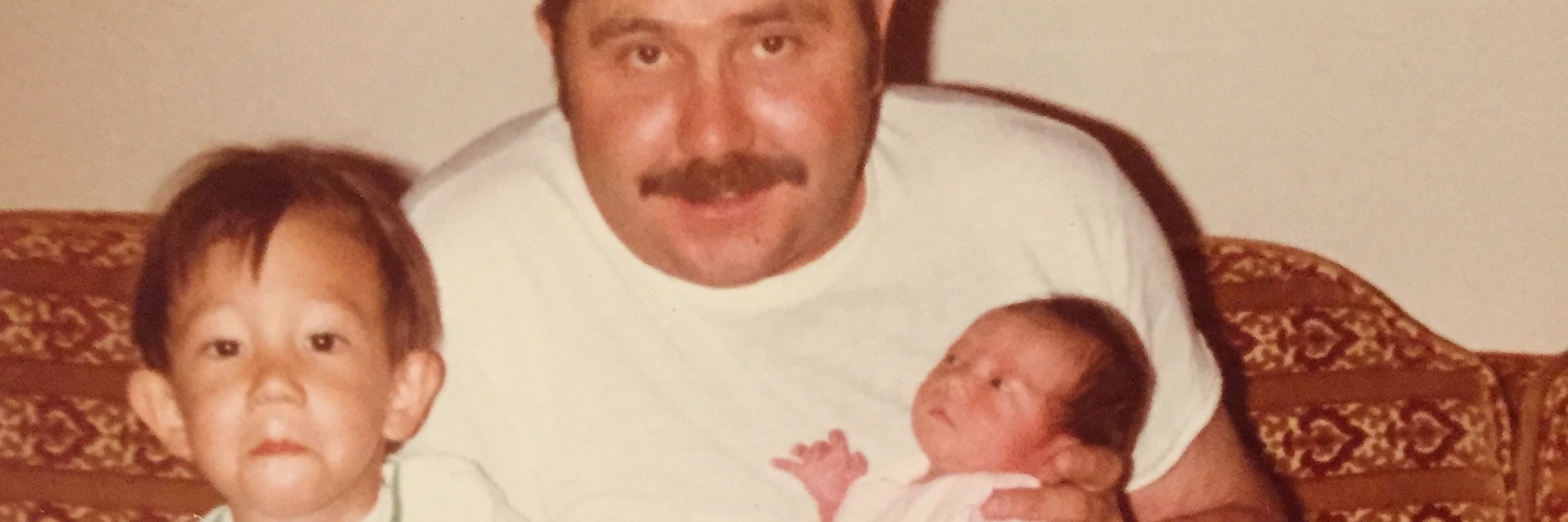 Thinking About Memories of My Father's Death on My Birthday old photograph of a father with young son and baby daughter