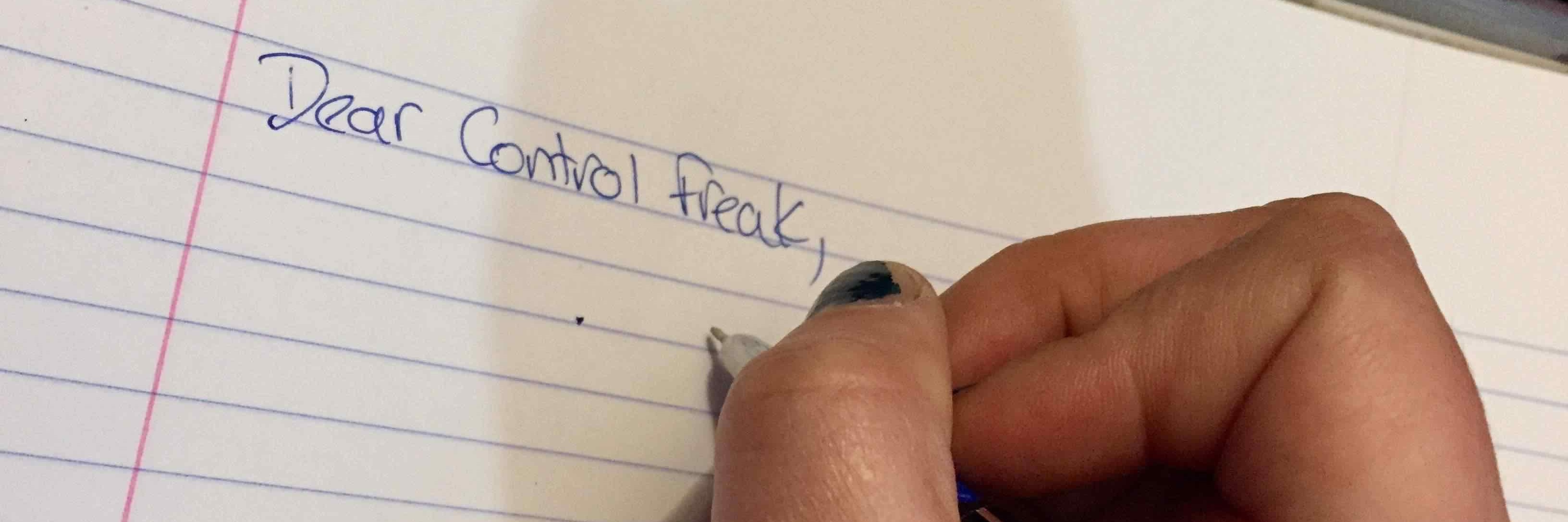 woman writing 'dear control freak' on a sheet of paper