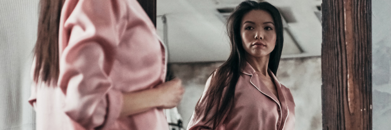 When You're Adopted and Don't Know Who You Are photo of asian woman standing in front of full-length mirror looking at her reflection