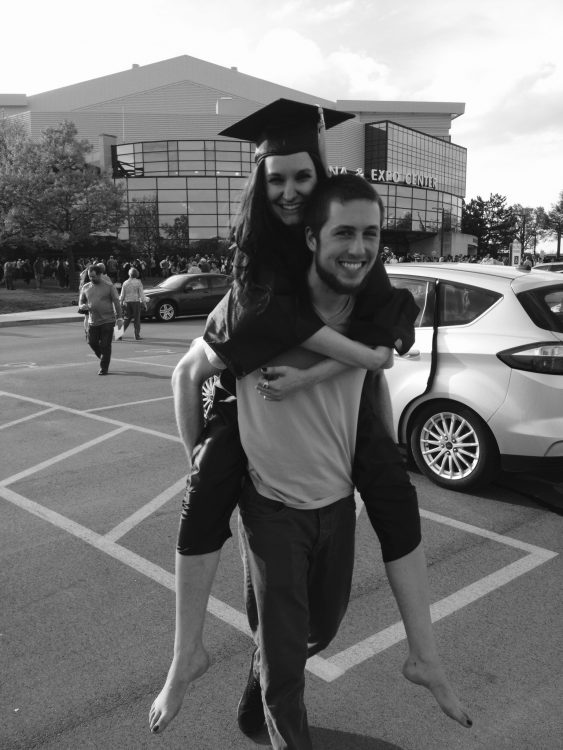 boyfriend carrying his girlfriend on his back on her graduation day