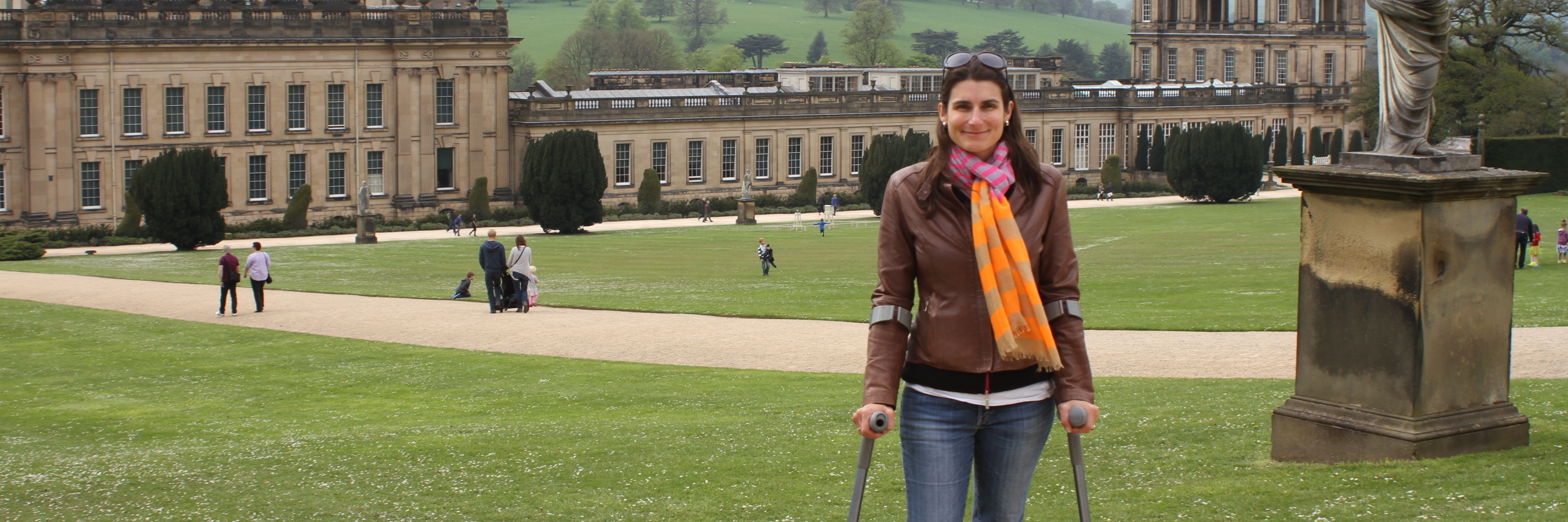 Seeking Diagnosis With Hypermobile Ehlers-Danlos Syndrome woman using walking devices and standing in front of large building