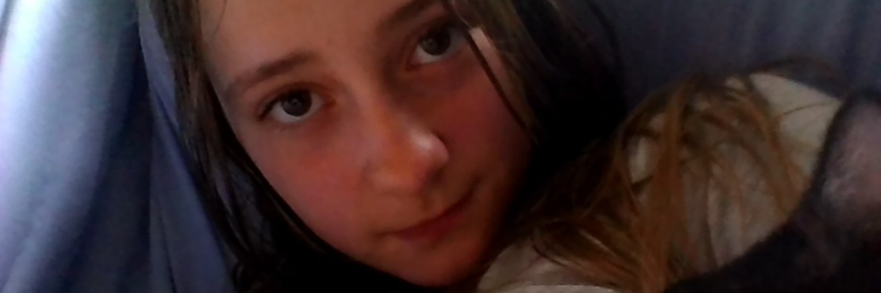 Parenting With Asthma, Cystic Fibrosis, Taking Care of Your Health young girl holding a kitten