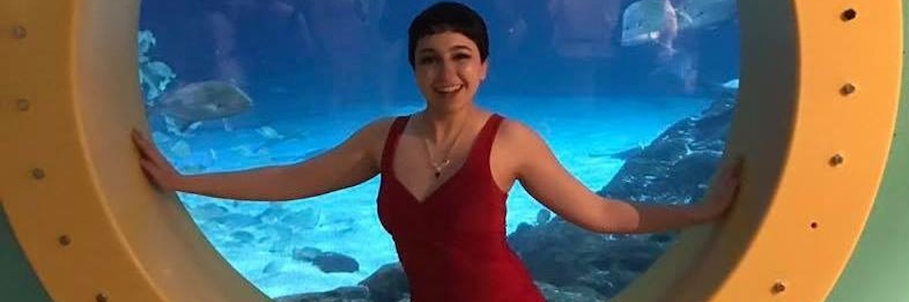 Gaining and Losing Weight With Ulcerative Colitis and Prednisone woman in red leotard sitting in a porthole of a cruise ship